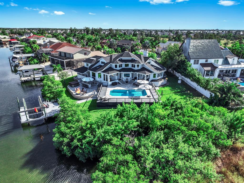 945 Bunker View Drive Apollo Beach, FL 33572 - Photo 2 of 92 an aerial view of a house with a garden and lake view