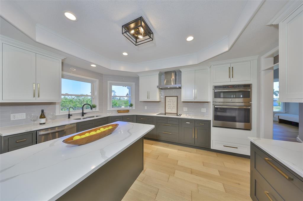 945 Bunker View Drive Apollo Beach, FL 33572 - Photo 27 of 92 a kitchen with stainless steel appliances granite countertop a sink counter space cabinets and stainless steel appliances