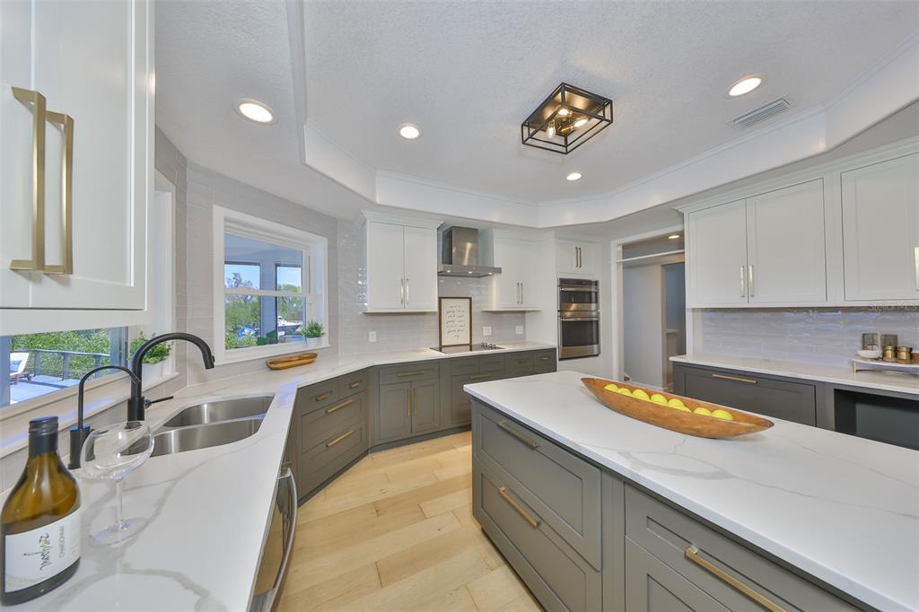 945 Bunker View Drive Apollo Beach, FL 33572 - Photo 28 of 92 a living room with stainless steel appliances granite countertop a sink a stove and a wooden floors