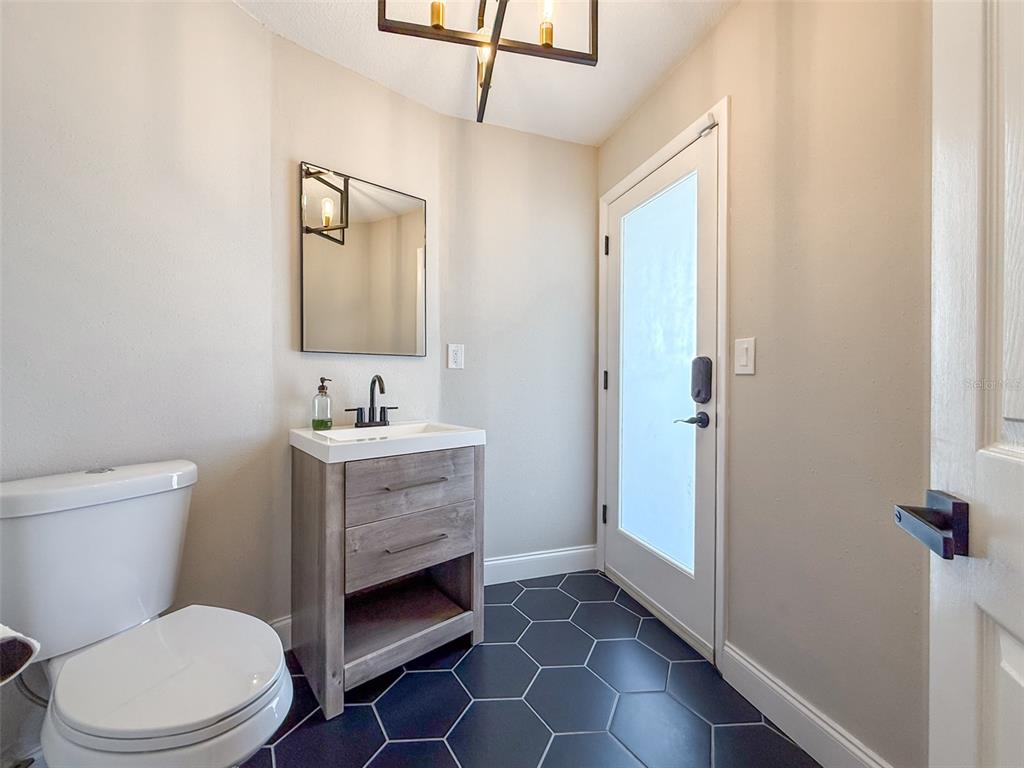 945 Bunker View Drive Apollo Beach, FL 33572 - Photo 33 of 92 a bathroom with a sink a toilet and shower