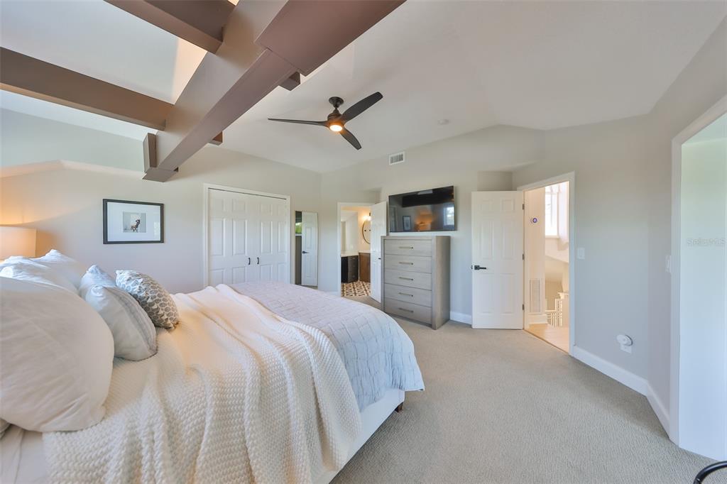 945 Bunker View Drive Apollo Beach, FL 33572 - Photo 44 of 92 a spacious bedroom with a bed and a chandelier