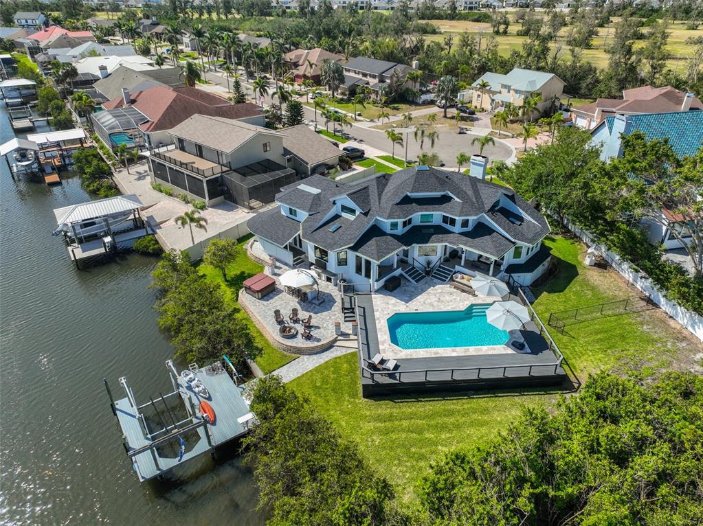 945 Bunker View Drive Apollo Beach, FL 33572 - Photo 5 of 92 an aerial view of a house with a garden and lake view