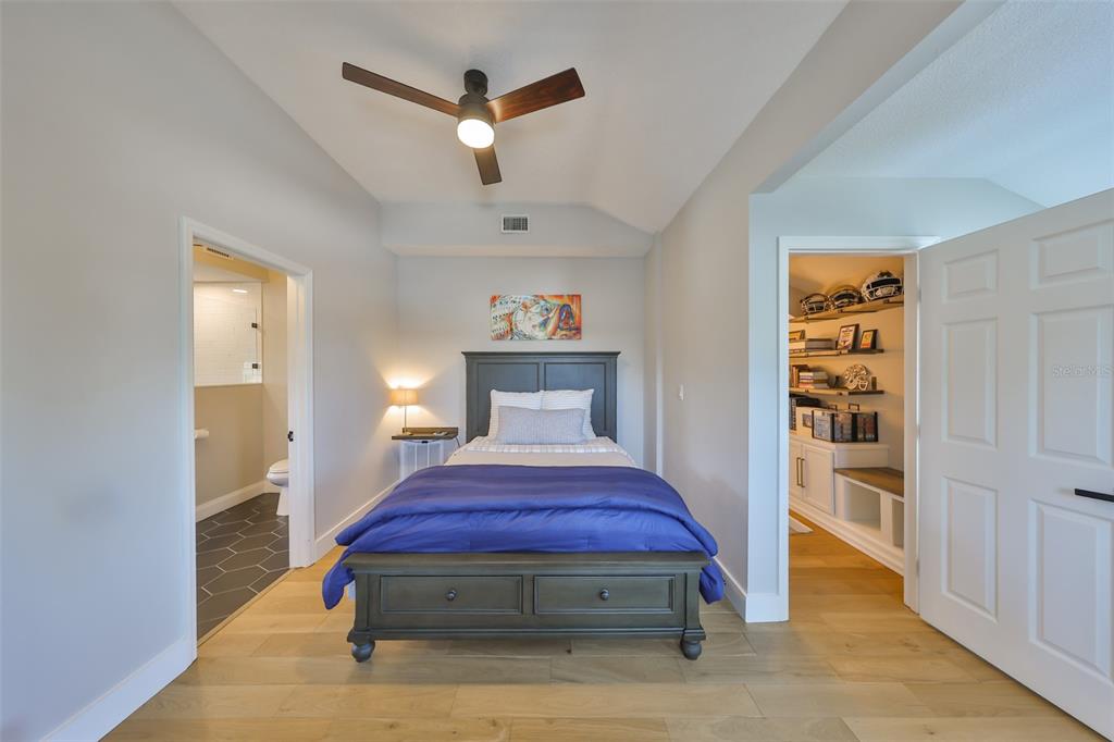 945 Bunker View Drive Apollo Beach, FL 33572 - Photo 53 of 92 a spacious bedroom with a bed and a chandelier