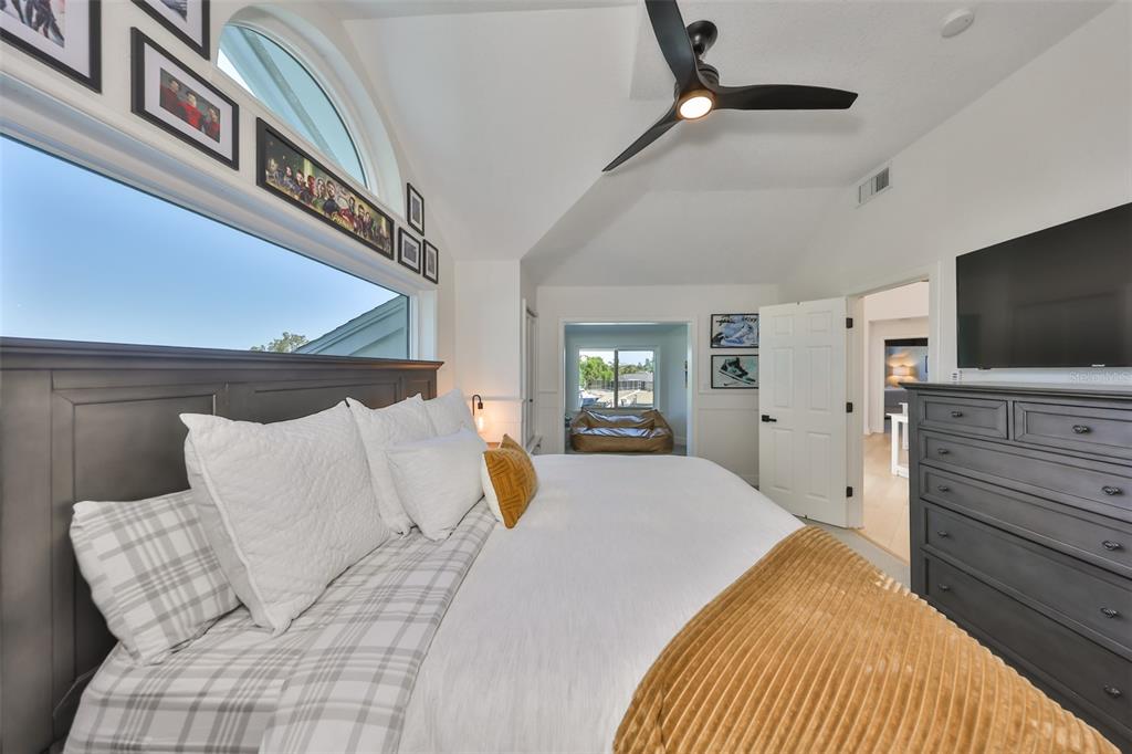 945 Bunker View Drive Apollo Beach, FL 33572 - Photo 57 of 92 a bedroom with a large bed and a flat screen tv