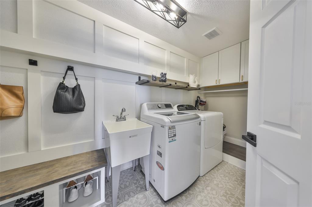 945 Bunker View Drive Apollo Beach, FL 33572 - Photo 65 of 92 a utility room with sink dryer and washer