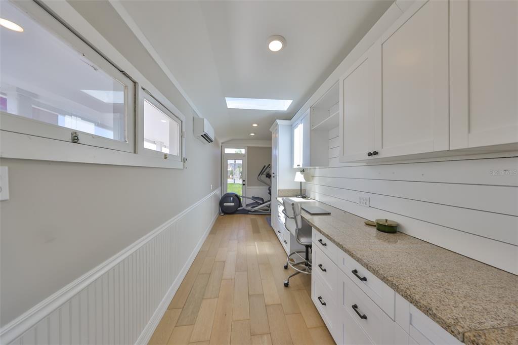 945 Bunker View Drive Apollo Beach, FL 33572 - Photo 66 of 92 a kitchen with granite countertop a sink stove and cabinets