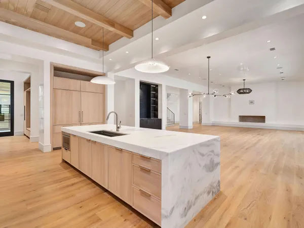 a kitchen with stainless steel appliances granite countertop a sink and a stove