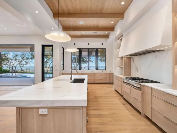 a large kitchen with stainless steel appliances granite countertop a large counter top and a stove