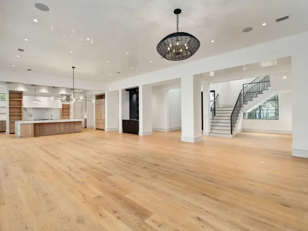 a view of an empty room with a kitchen