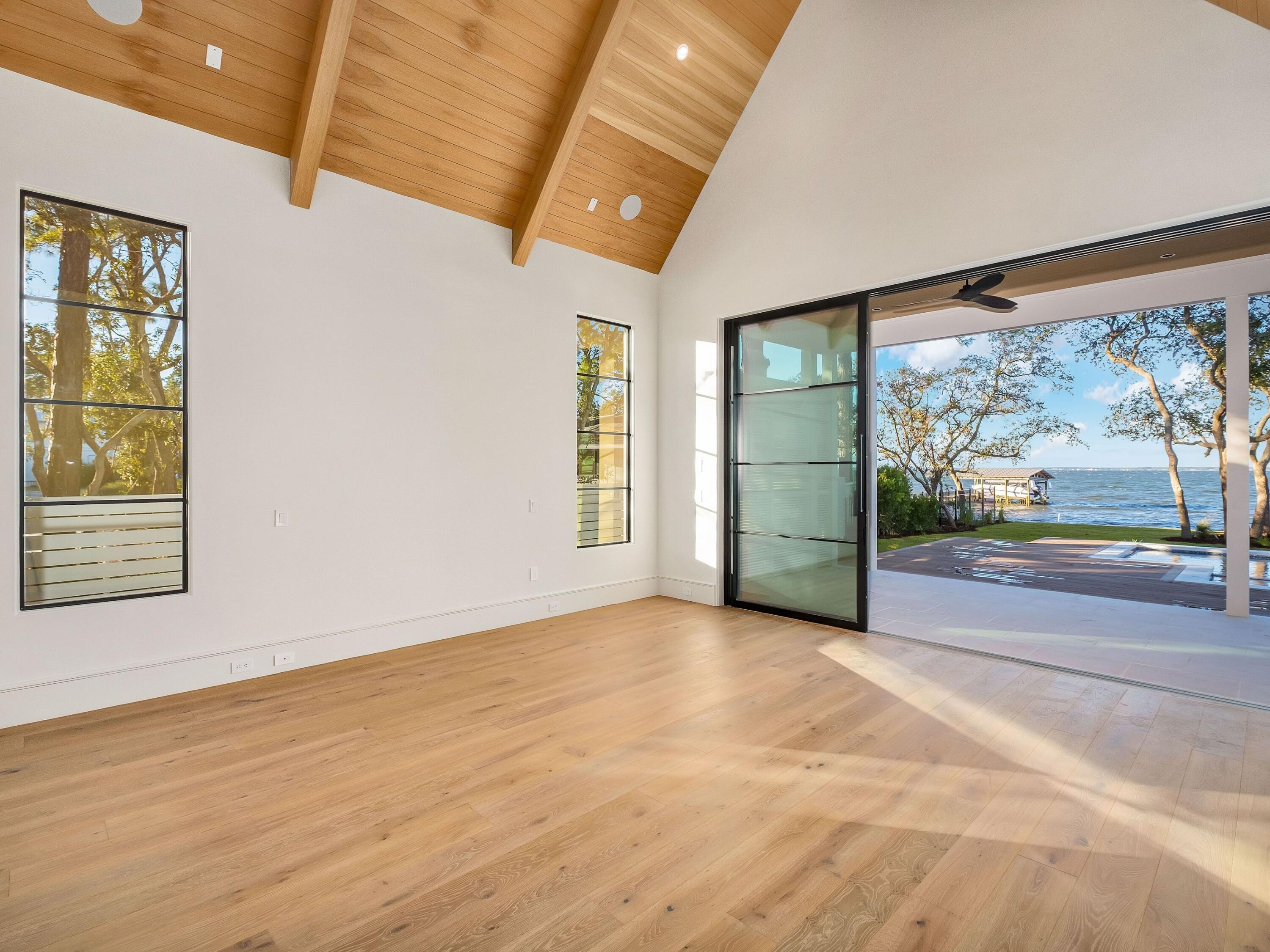431 Pisces Drive Santa Rosa Beach, FL 32459 - Photo 23 of 48 an empty room with wooden floor and windows