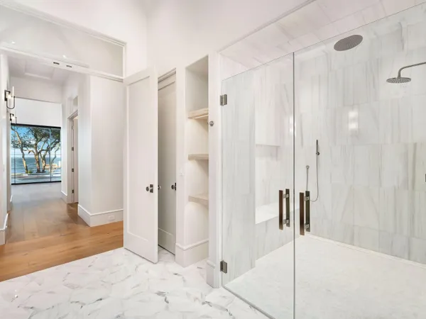 a bathroom with a shower and a glass door