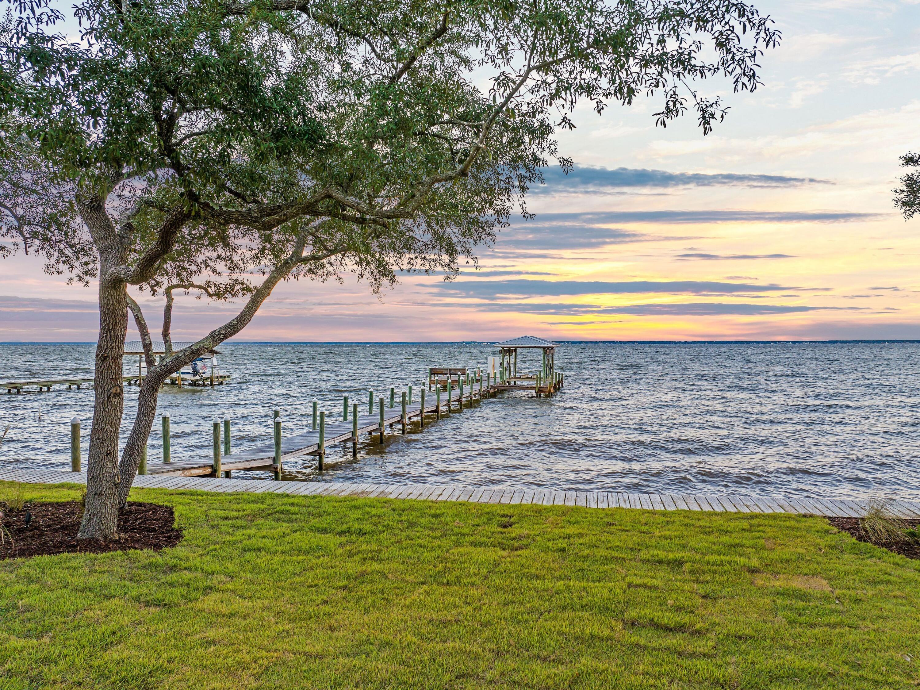 431 Pisces Drive Santa Rosa Beach, FL 32459 - Photo 5 of 48 a view of a swimming pool with a lawn chairs and floor to ceiling window