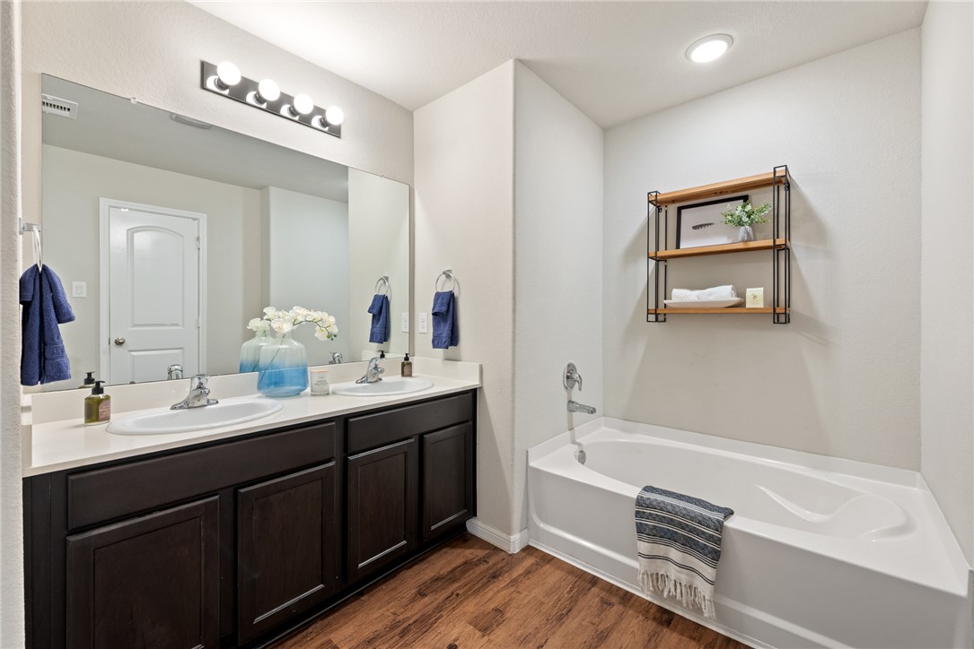 2018 Eagle View Drive Navasota, TX 77868 - Photo 18 of 28 a bathroom with a tub a sink and mirror