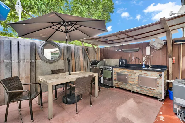 a view of a chairs and table in the back yard