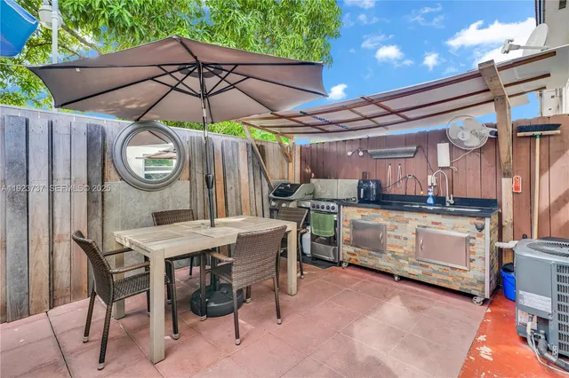 a view of a dinning table and chairs in the patio