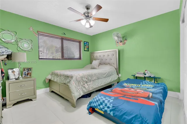 a bedroom with two beds and a chandelier