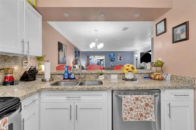 a kitchen with sink and a mirror