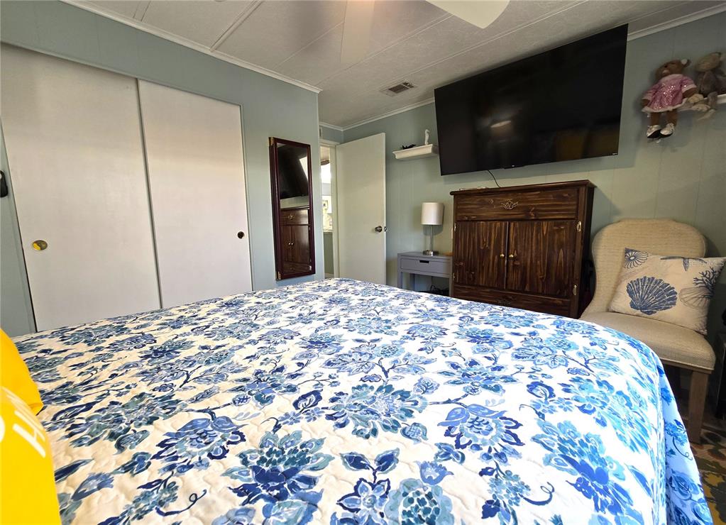 5619 Bayshore Road, Unit 435 Palmetto, FL 34221 - Photo 20 of 56 a bedroom with a bed and a flat screen tv