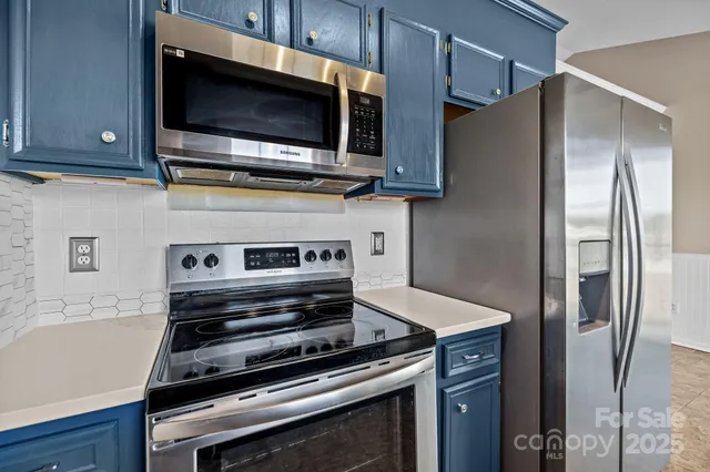 a kitchen with wooden cabinets and stainless steel appliances
