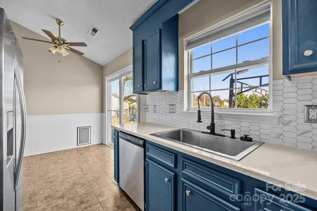a kitchen with a sink and a refrigerator