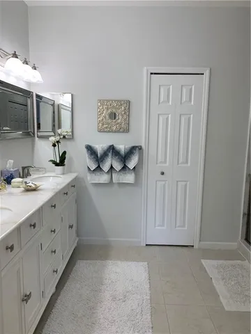 a bathroom with a double vanity sink and a mirror
