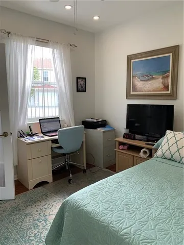 a bedroom with a bed and a desk