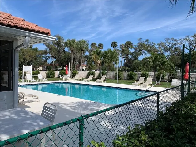 a view of a swimming pool with a patio and a fire pit