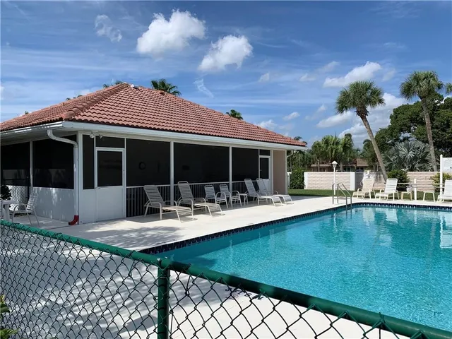 a view of house with swimming pool outdoor seating