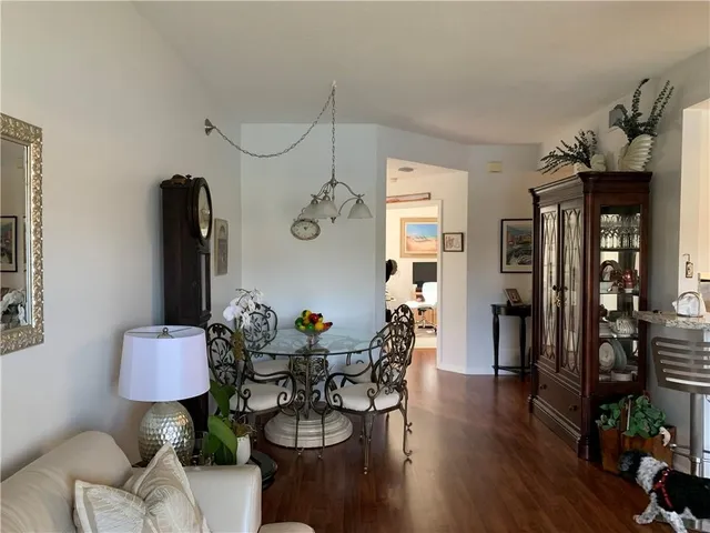 a view of a workspace with furniture and wooden floor