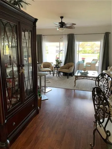 a living room with furniture and large windows
