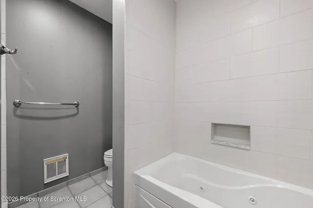 a bathroom with a double vanity sink mirror and shower
