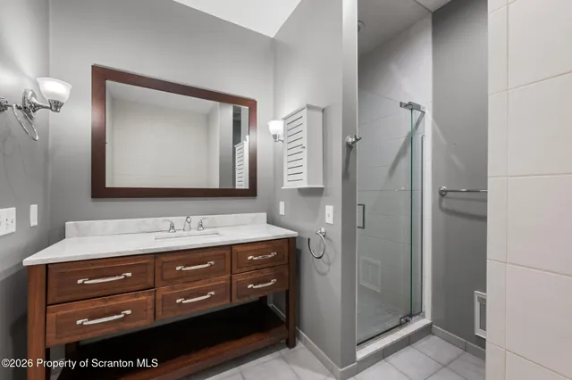 a bathroom with a tub a sink and mirrors