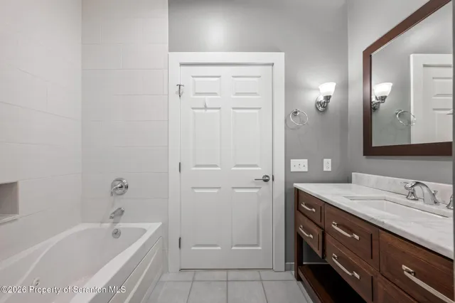 a view of an empty room with wooden floor and closet