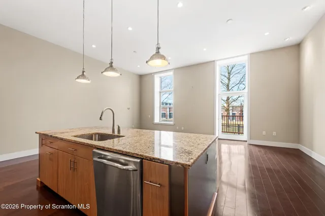 a kitchen with stainless steel appliances granite countertop a sink stove and cabinets