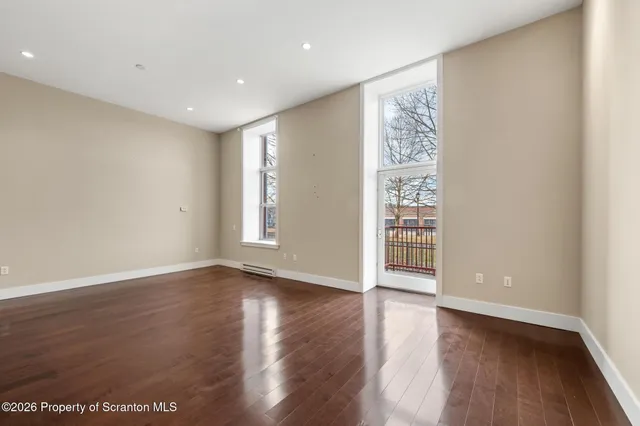 a view of a kitchen with furniture and a wooden floor
