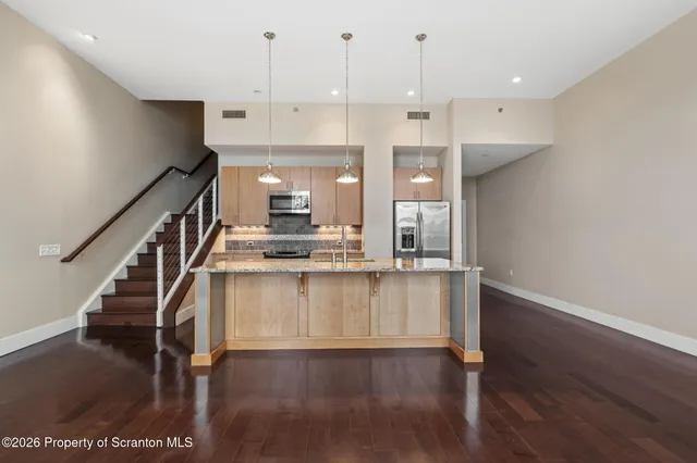 a view of a kitchen from a corridor