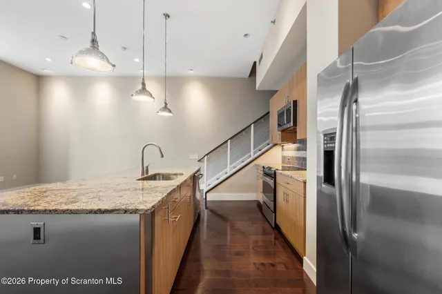 a view of hallway with hardwood floor and window