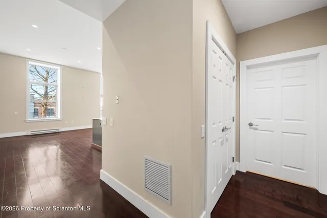 a bathroom with a granite countertop sink toilet and a mirror