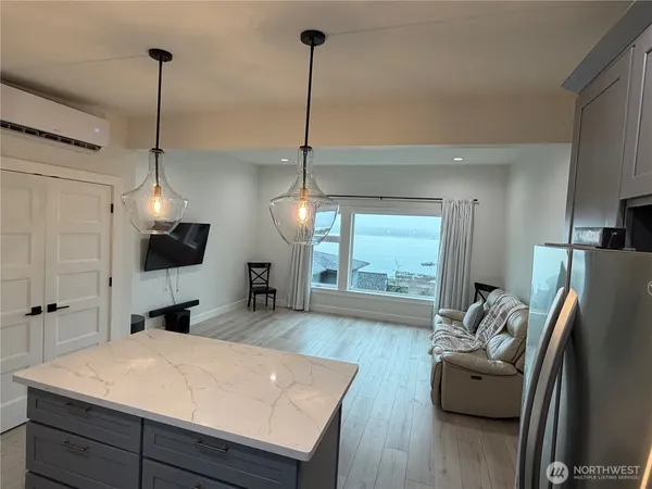 a kitchen with a refrigerator a sink and wooden floor