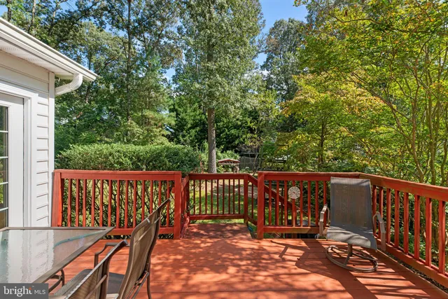 a view of a wooden deck with a big yard