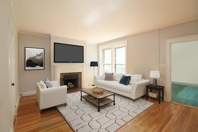 a living room with furniture a flat screen tv and a fireplace