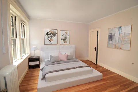 a bedroom with a large bed and a window