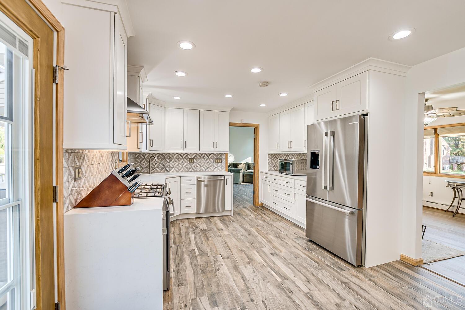 37 Utica Road Edison, NJ 08820 - Photo 13 of 53 a kitchen with a refrigerator and a stove top oven