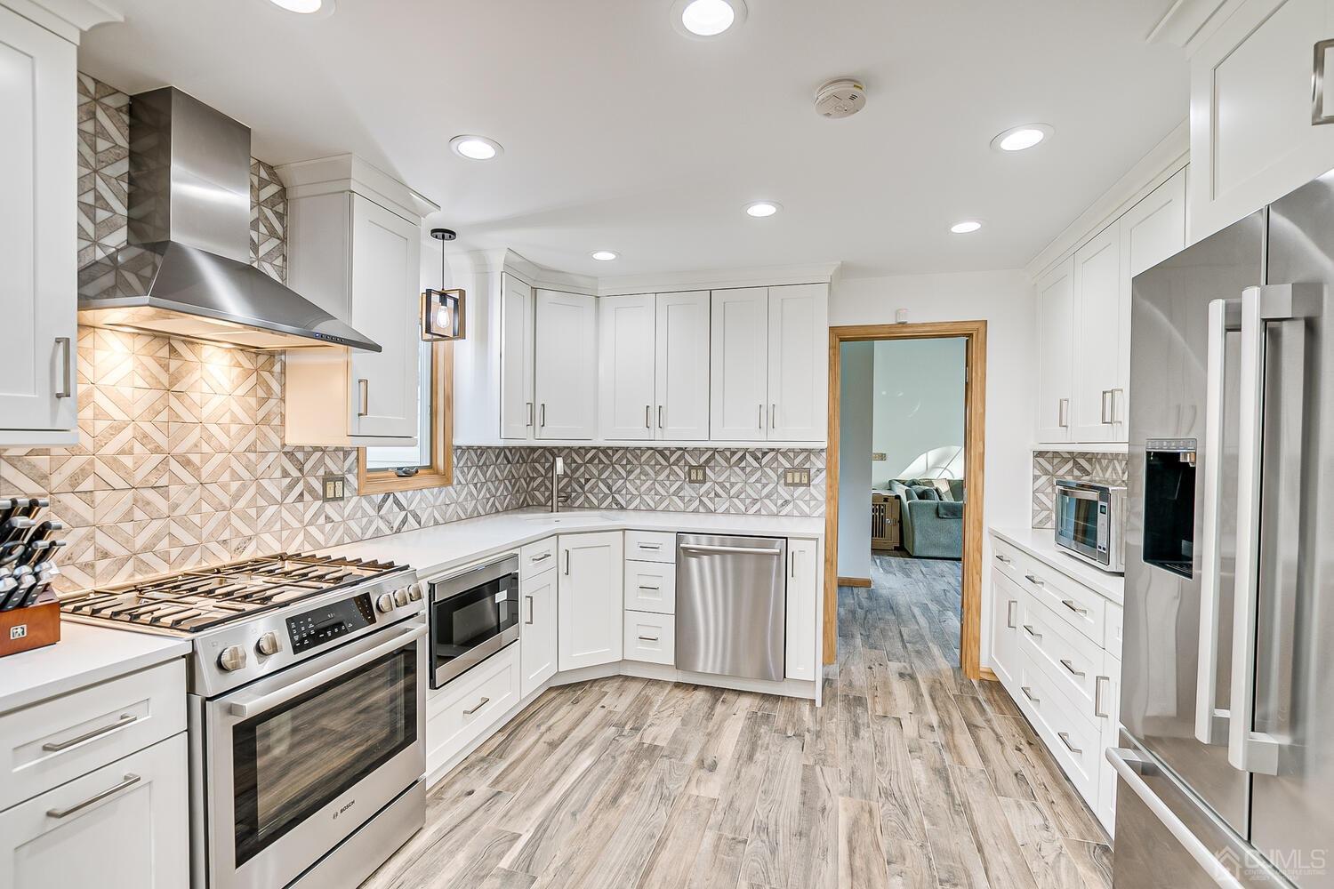 37 Utica Road Edison, NJ 08820 - Photo 14 of 53 a large kitchen with stainless steel appliances granite countertop a stove and a sink