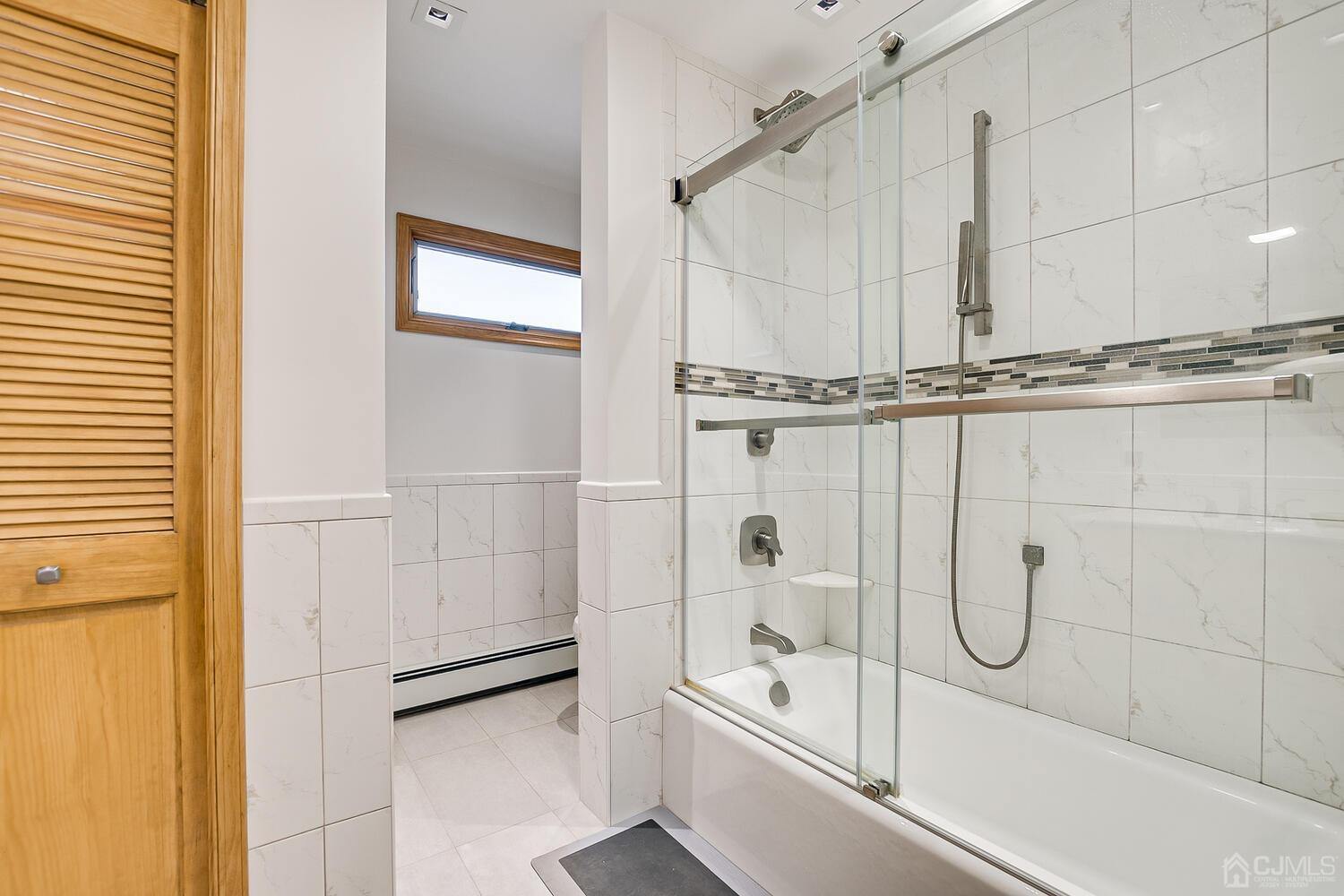 37 Utica Road Edison, NJ 08820 - Photo 24 of 53 a bathroom with a tub shower vanity and a sink