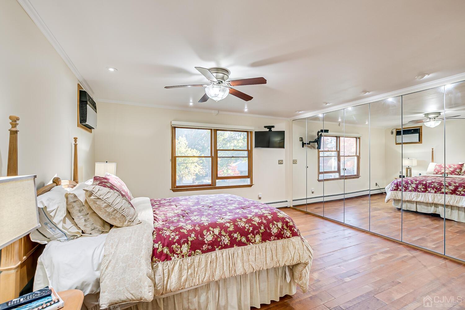 37 Utica Road Edison, NJ 08820 - Photo 31 of 53 a bedroom with a large bed and a chandelier