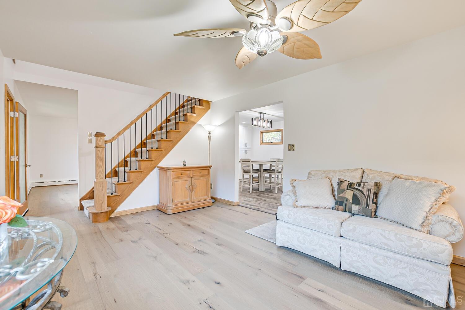 37 Utica Road Edison, NJ 08820 - Photo 9 of 53 a living room with furniture and a chandelier