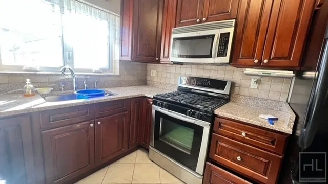 a kitchen with a stove microwave and sink