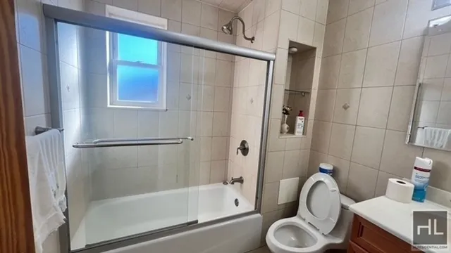 a bathroom with a shower a sink and a toilet