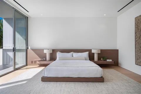a bathroom with a double vanity sink mirror and bathtub